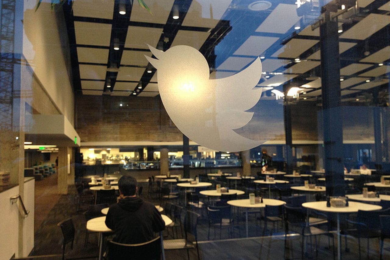 Twitter logo on glass wall behind restaurant