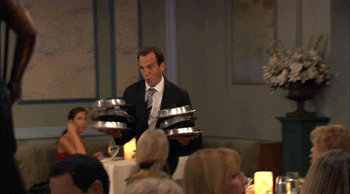 Waiter carrying lots of plates