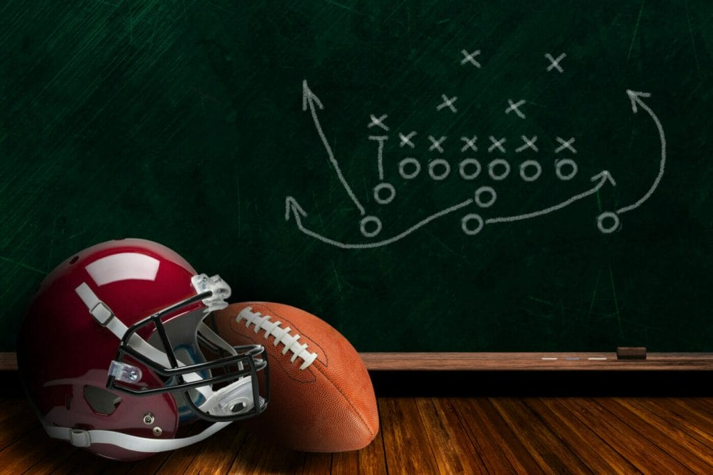 Football,Helmet,And,Ball,With,Play,Strategy,Drawn,On,A